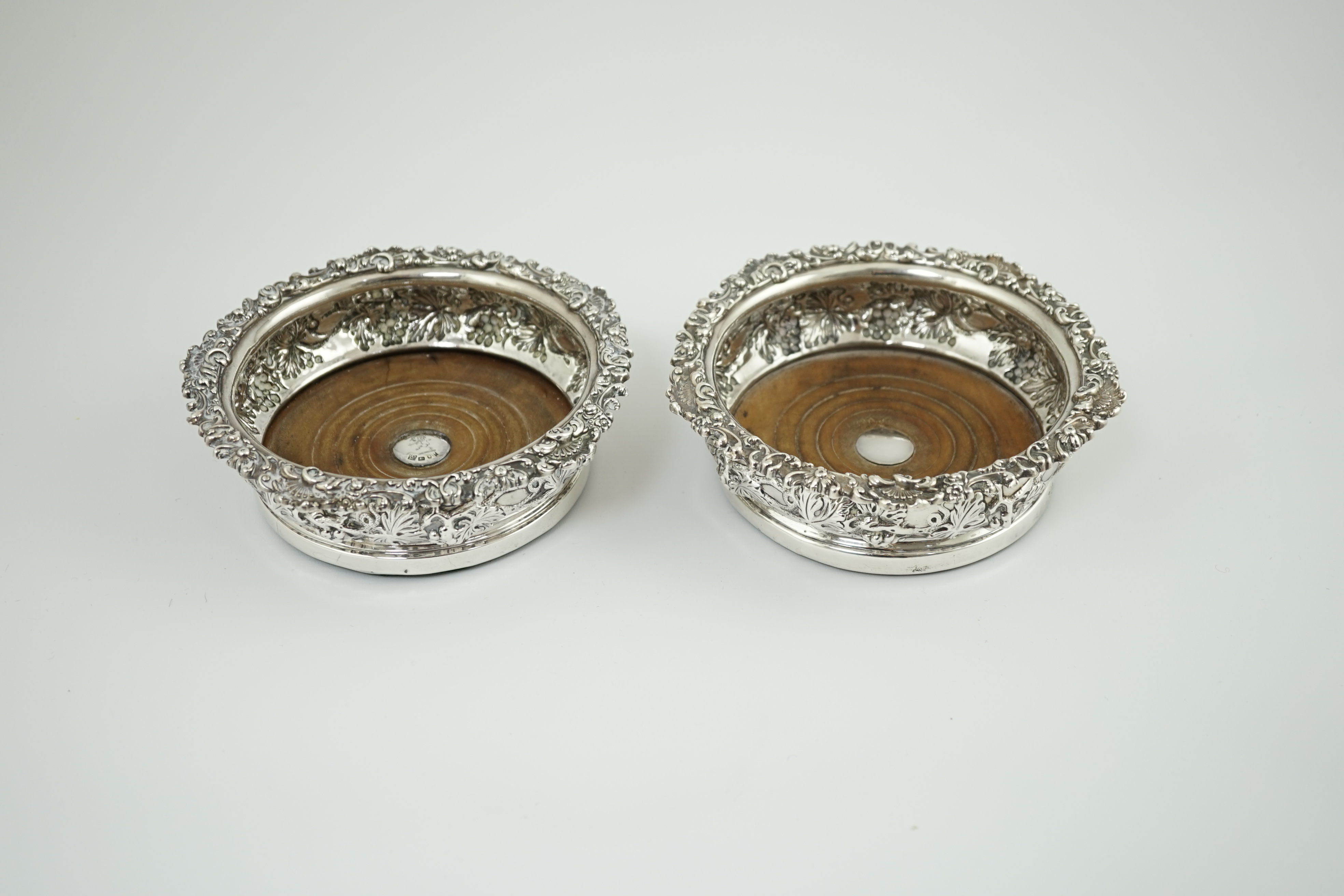 A pair of George IV silver wine coasters, by S.C. Younge & Co